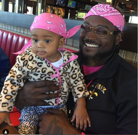 fasskash holding daughter kashmir wearing pink bandanas 
